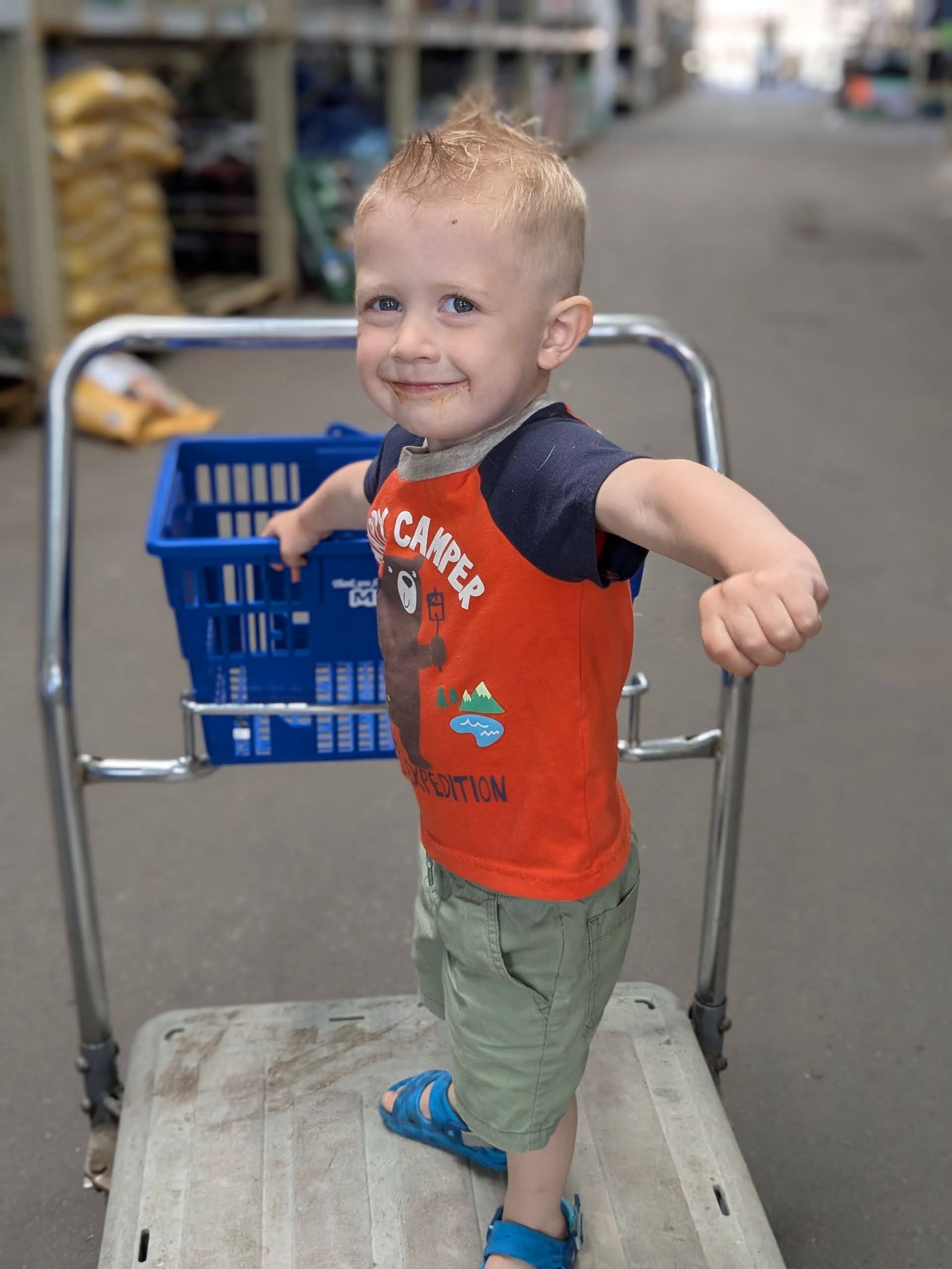 Oscar riding a shopping cart