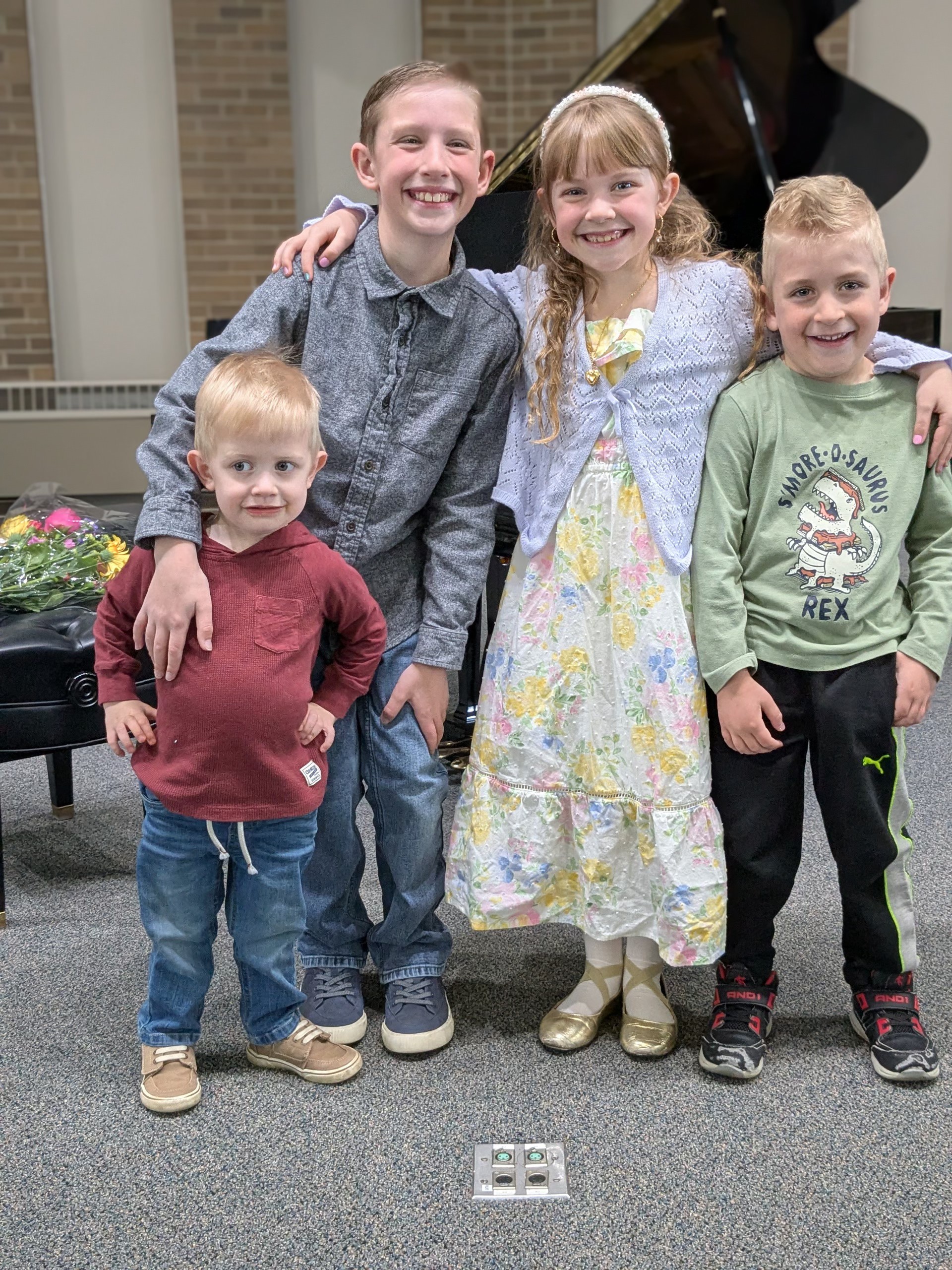 Oscar with siblings by the piano
